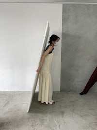two people standing in front of a white wall